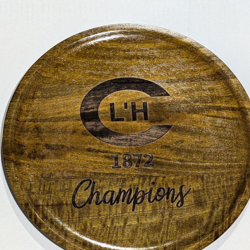 Engraved logo on a wooden charger plate for the winners of a Tennis Tournament